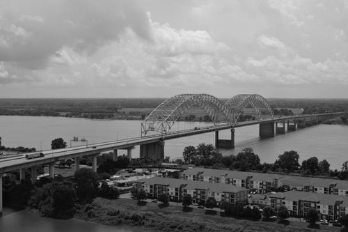 Free A black and white aerial view of Hernando de Soto Bridge spanning the Mississippi River in Memphis. Stock Photo