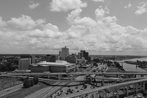 Free Black and white aerial view of Memphis skyline with prominent roads and clouds in the background. Stock Photo