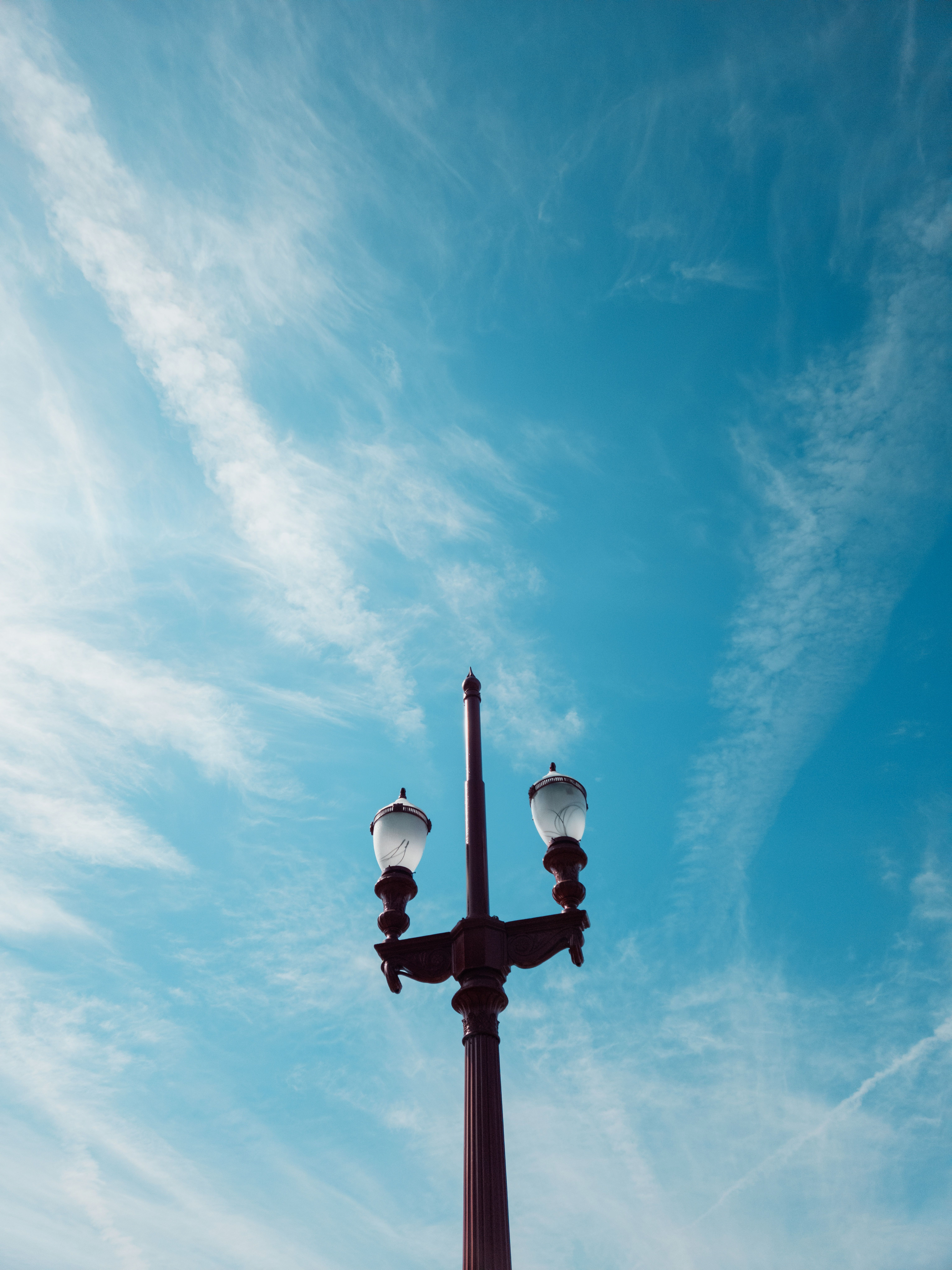 Classic street lamp silhouetted against a vibrant blue sky in Belo Horizonte, Brazil.
