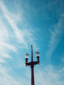 Classic street lamp silhouetted against a vibrant blue sky in Belo Horizonte, Brazil.