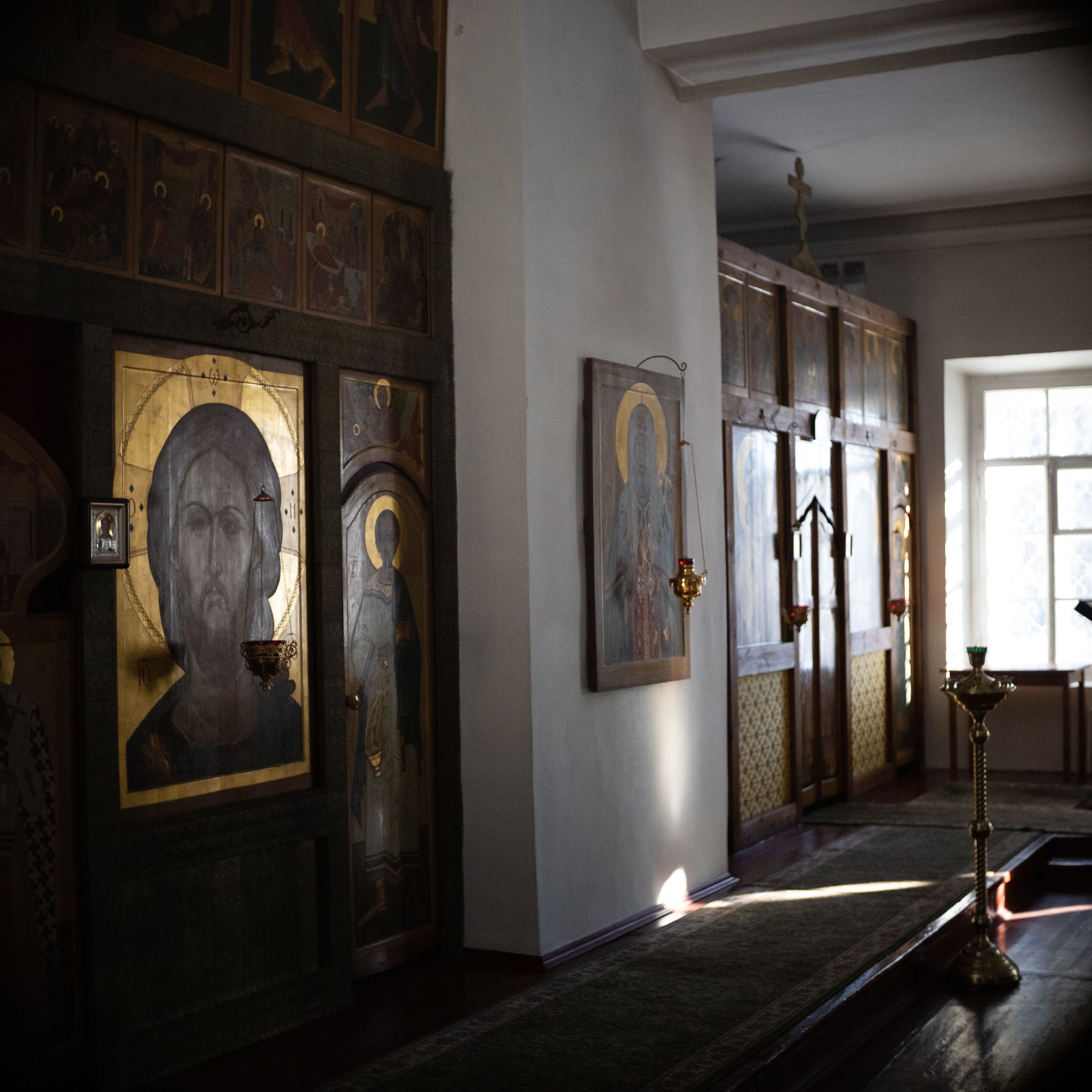 Tranquil setting in an Orthodox church, showcasing religious icons and soft natural lighting.