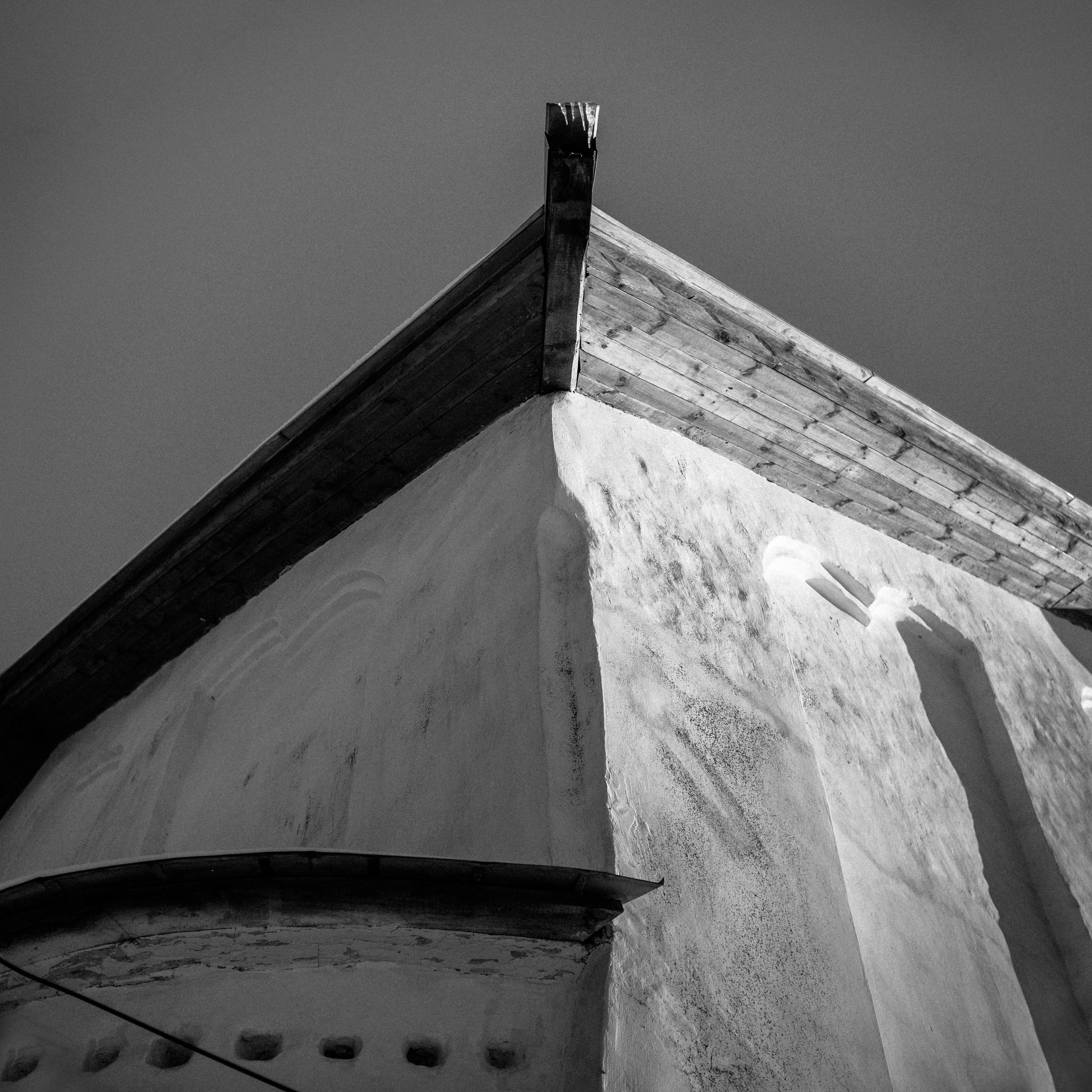 Moody black and white photo of historical building facade captures architectural details.