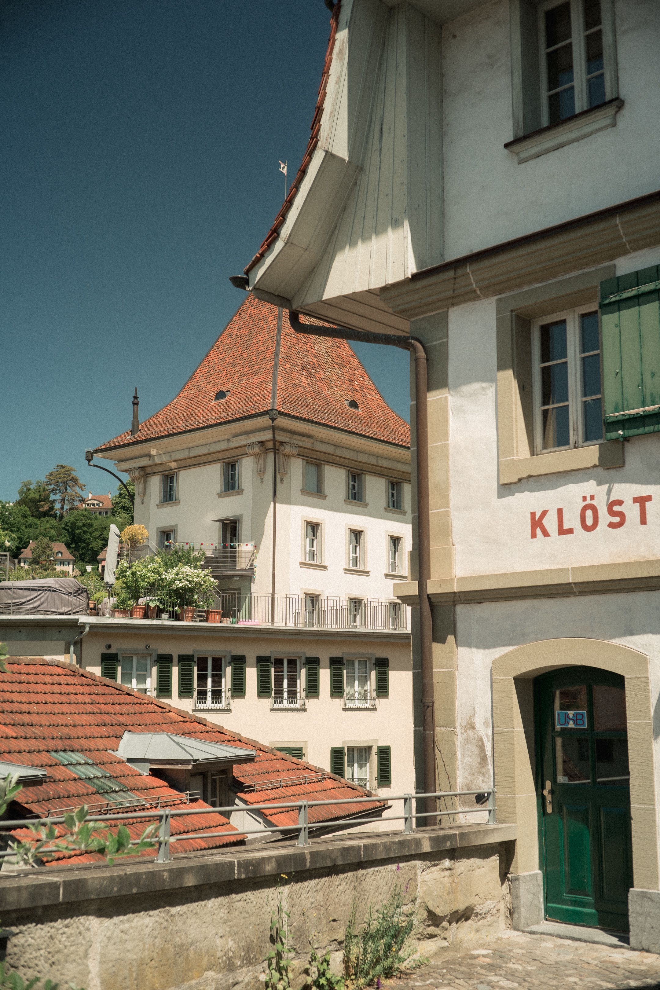 Charming European architecture featuring red-tiled roofs and vintage facades on a sunny day.