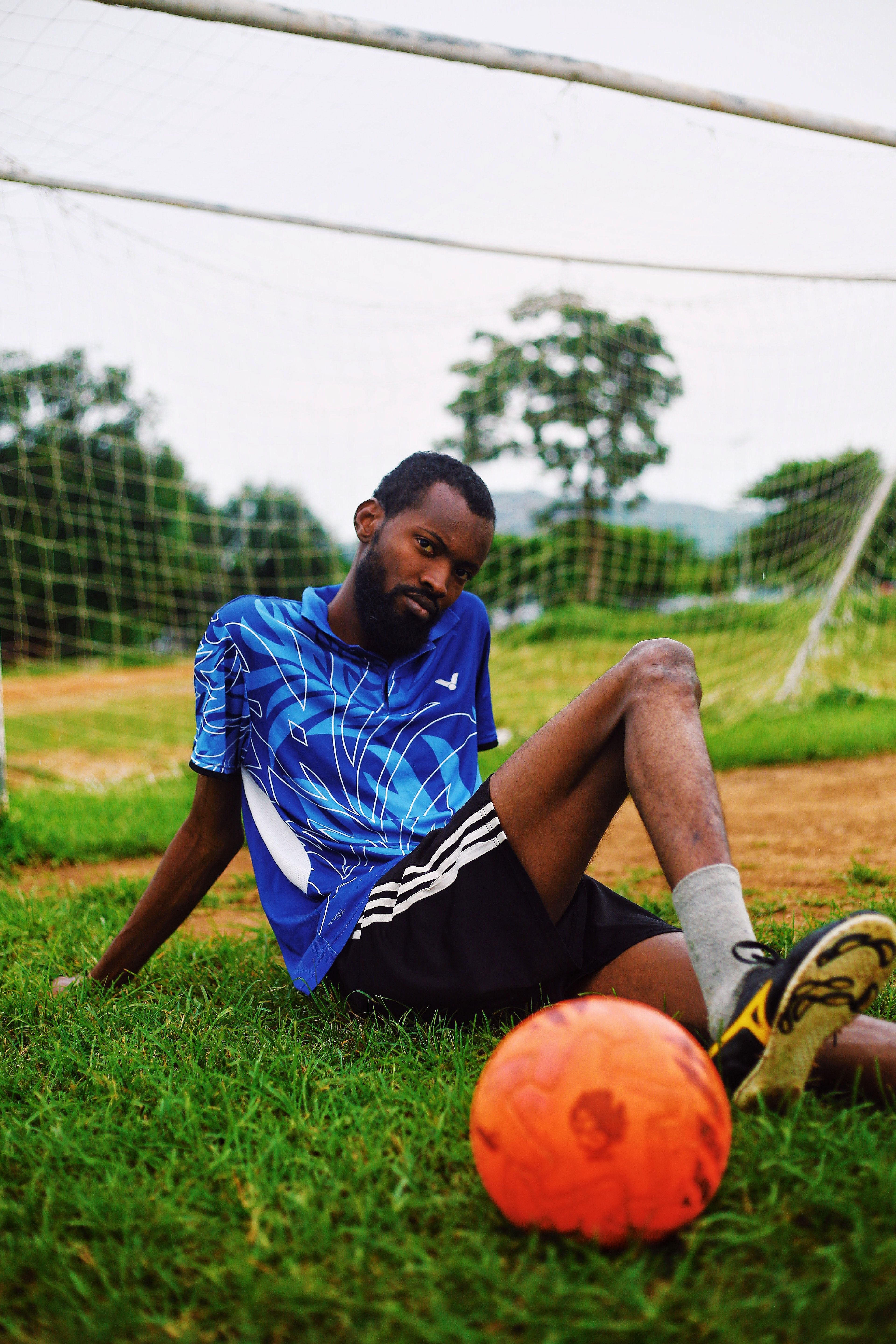 Soccer player relaxing on a field in Nigeria