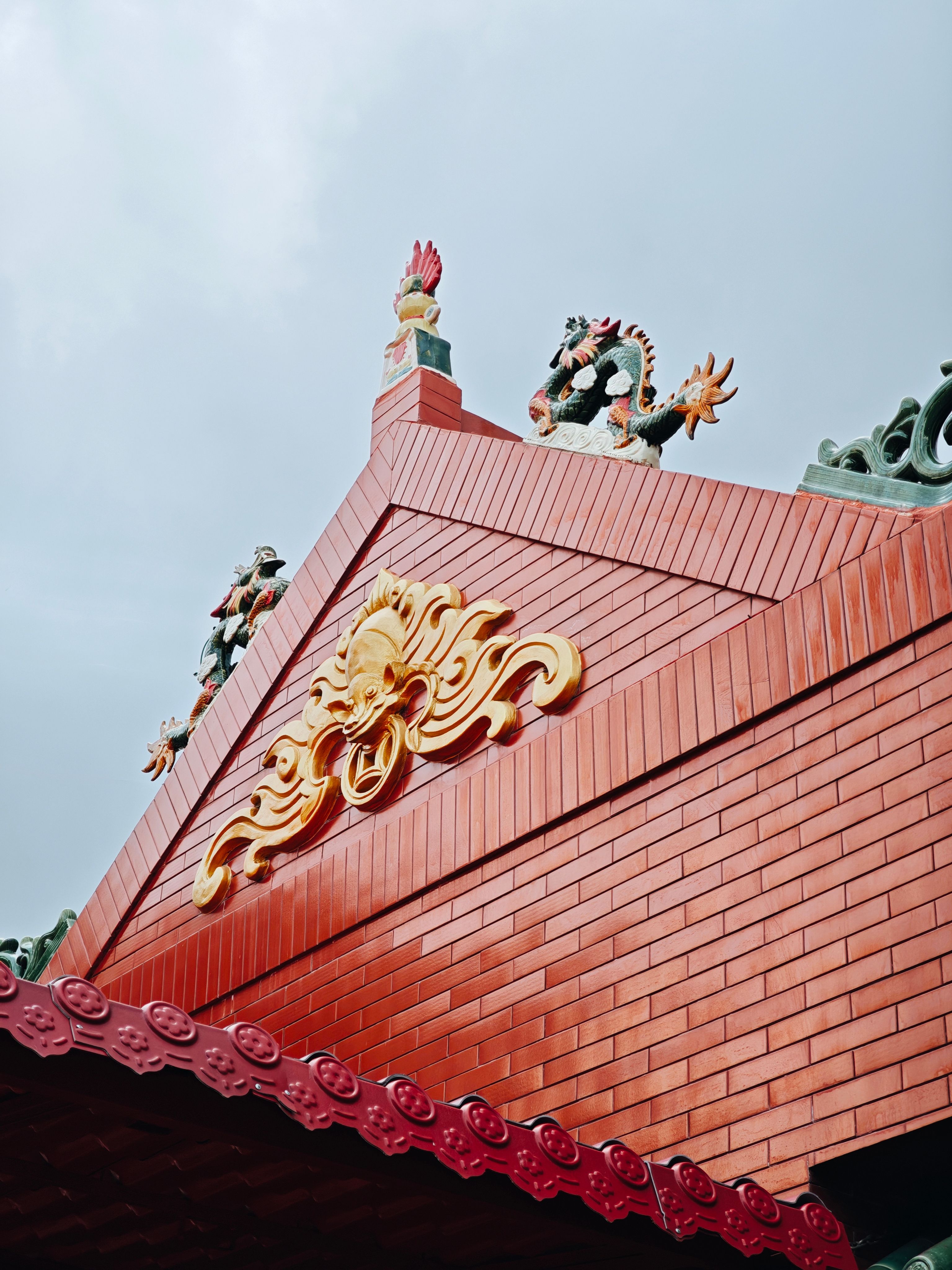 Detailed view of ornate Asian temple roof with dragon decor.