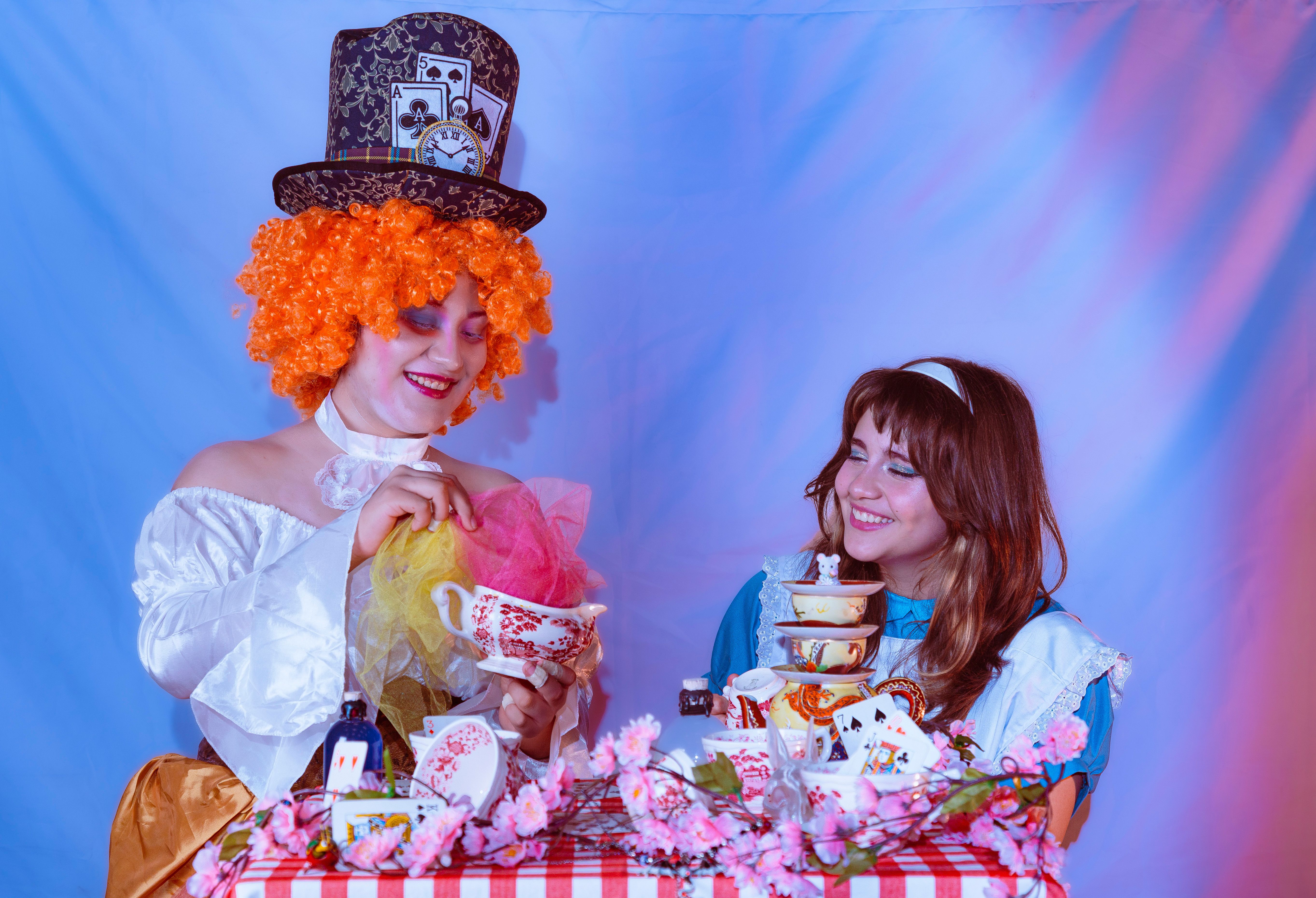 Colorful Alice in Wonderland themed tea party with vibrant costumes and decorations.