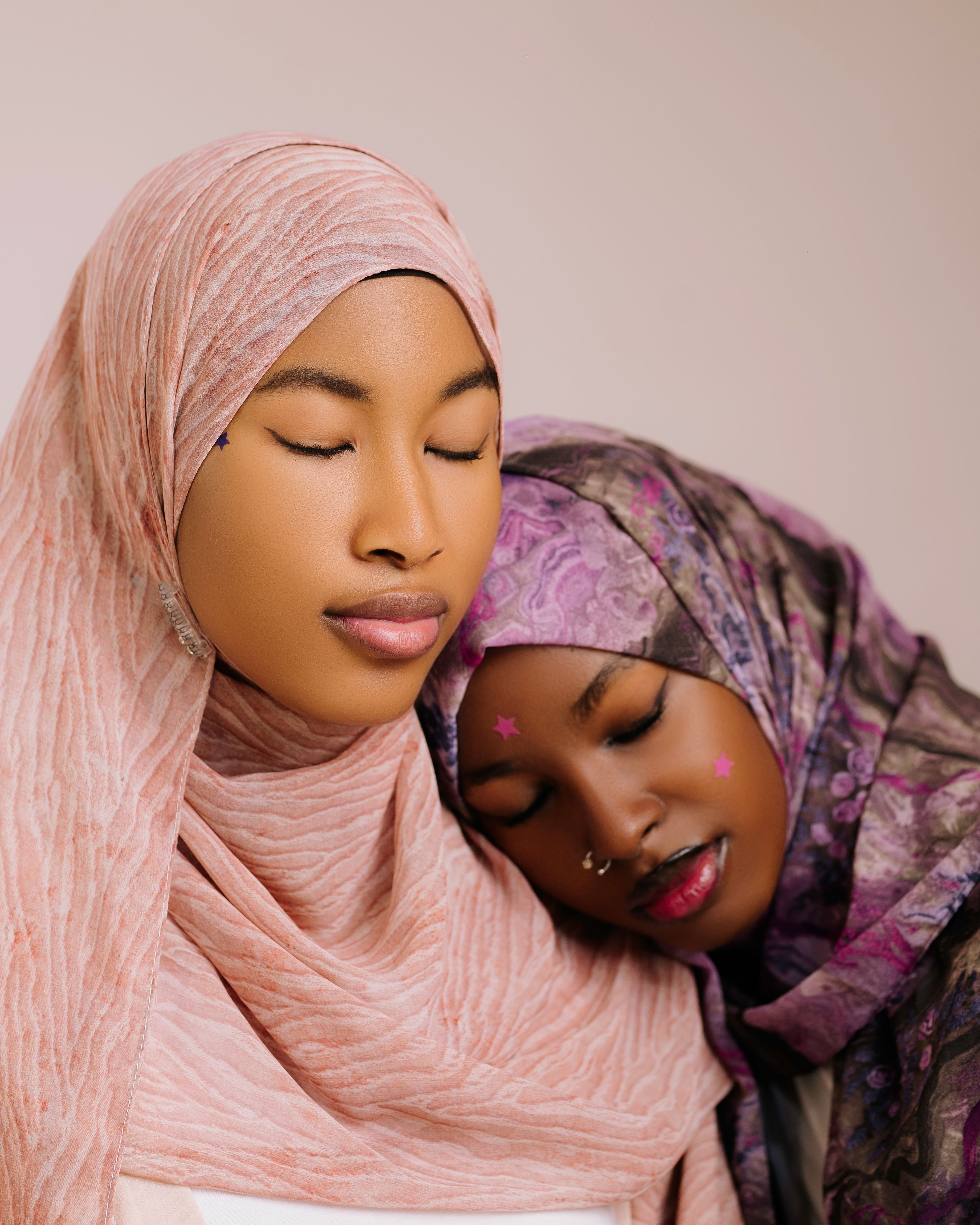 Peaceful portrait of two women in hijabs, highlighting cultural beauty and friendship.