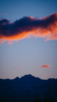 Dramatic mountain silhouette against a vibrant sunset sky in Córdoba, Argentina.