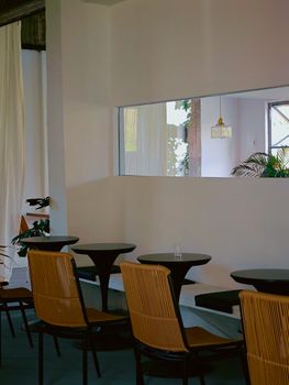 Explore a modern café interior with minimalist design and empty seating arrangement.