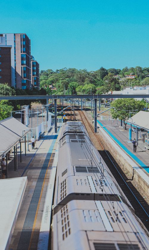Free A train at a bustling station on a bright day under a clear blue sky. Stock Photo