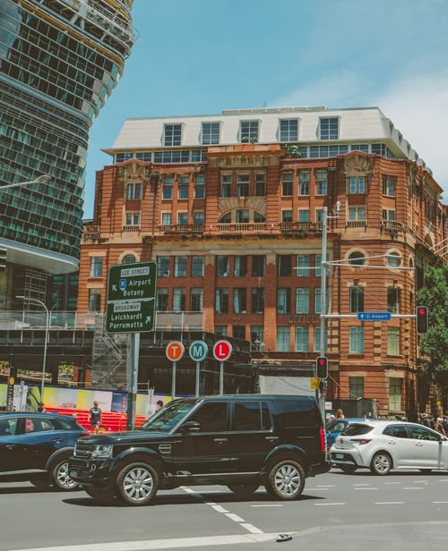 Free Vibrant city intersection in Sydney with historical buildings and modern traffic. Stock Photo