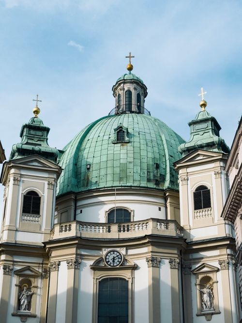 Free The iconic green dome of St. Peter's Church in Vienna under a clear blue sky. Stock Photo