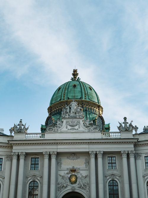 Free Majestic view of Hofburg Palace's green dome in Vienna, showcasing exquisite Baroque architecture against a clear sky. Stock Photo