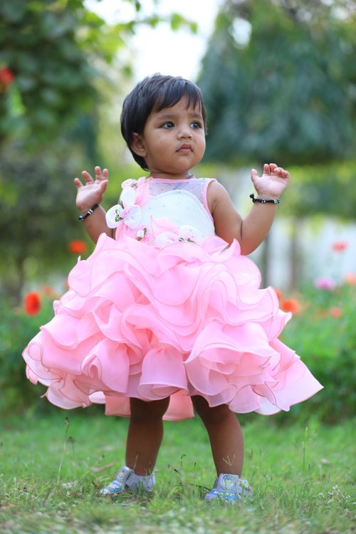 Little Girl in Pink Dress Holding Flowers · Free Stock Photo