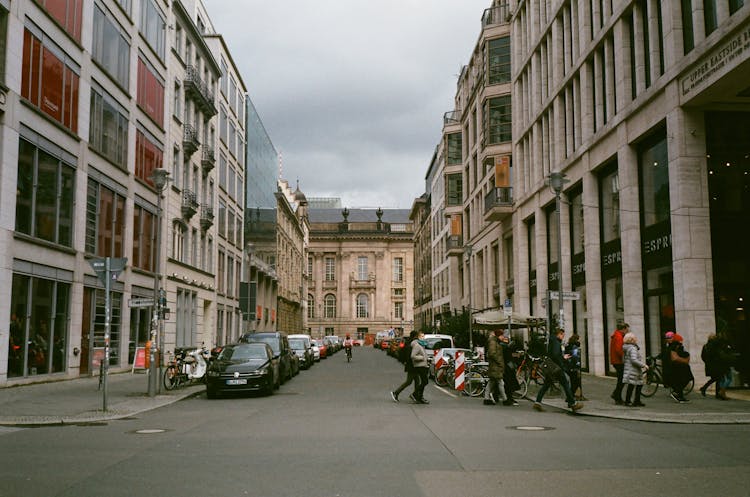 Aged Building Facades With People Crossing City Road