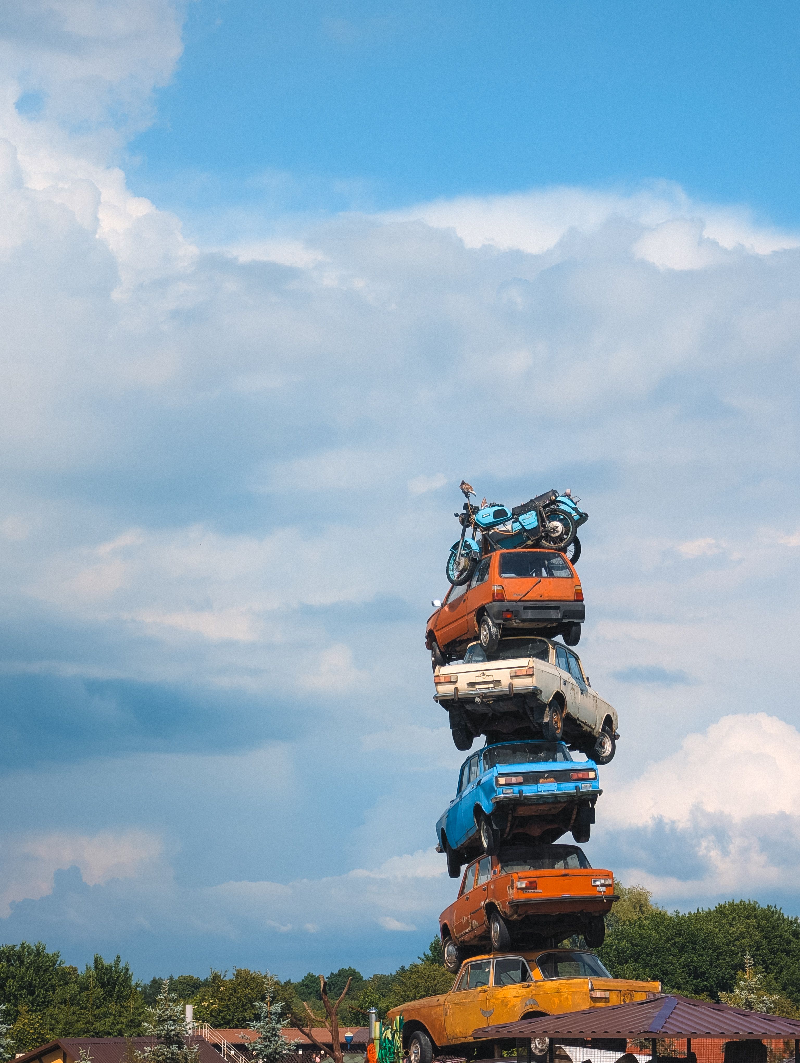 Stack of Vintage Cars Against the Sky · Free Stock Photo