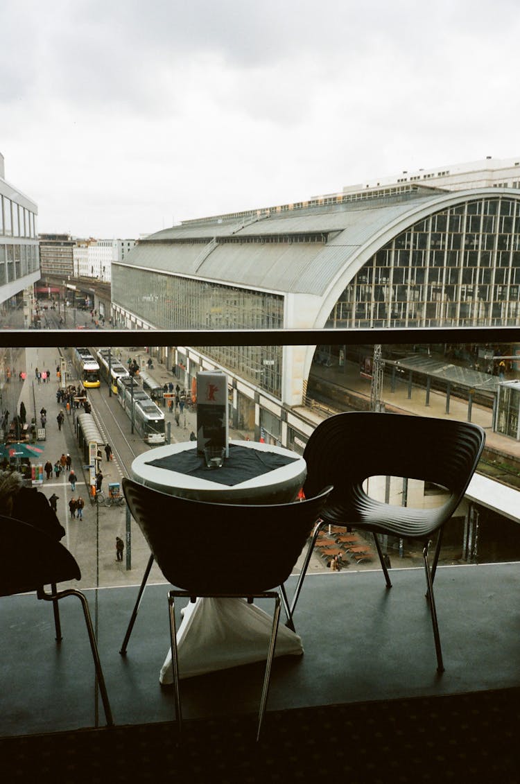 Modern Cafe Near Buildings In City Under Cloudy Sky