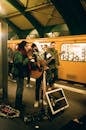 Musicians playing guitar on subway station