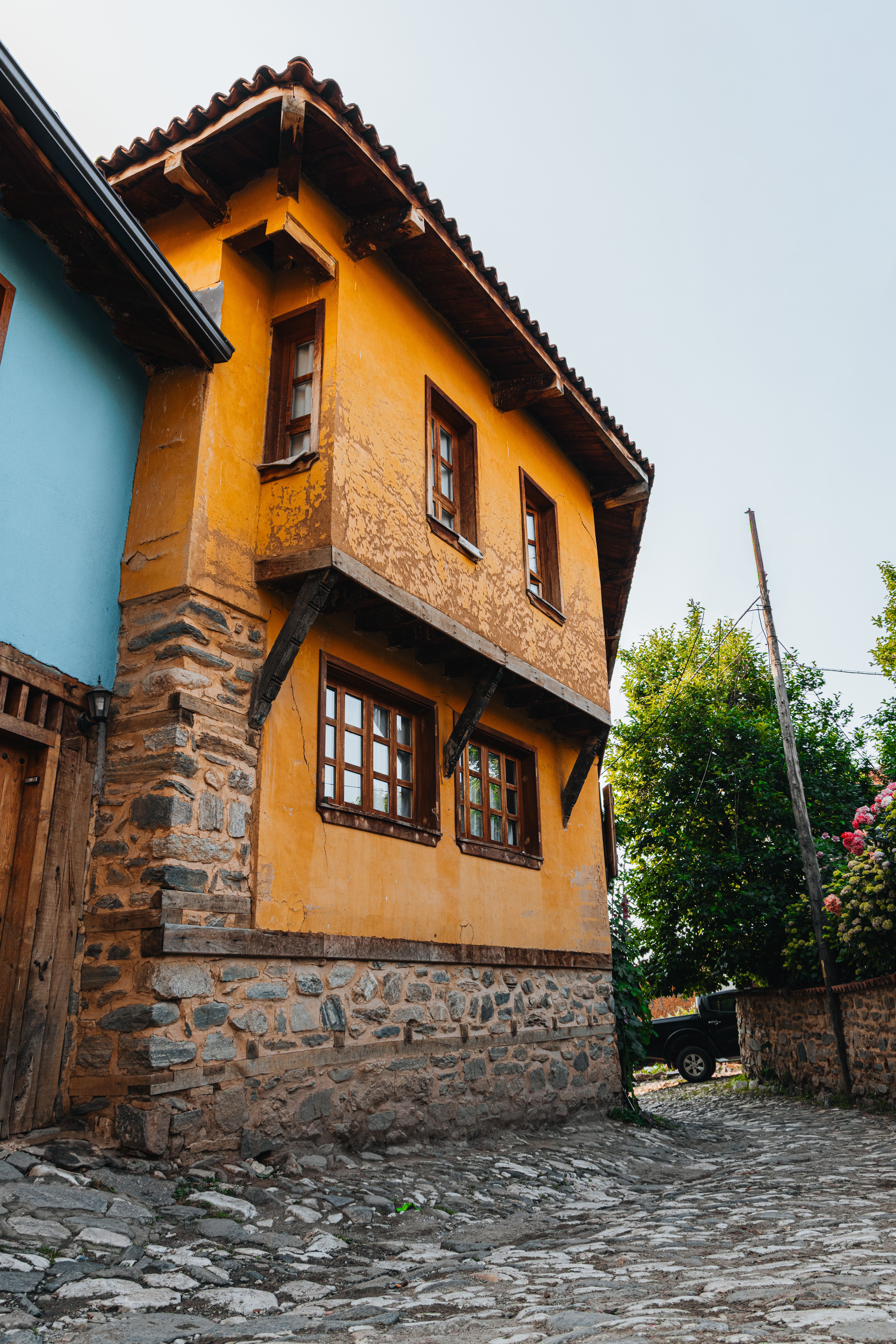 Colorful rustic house with wooden and stone details in a quaint village setting, perfect for travel and architecture themes.