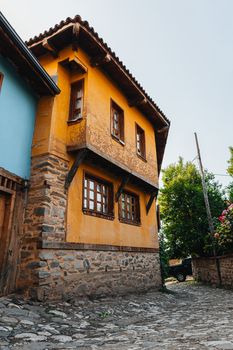 Colorful rustic house with wooden and stone details in a quaint village setting, perfect for travel and architecture themes.