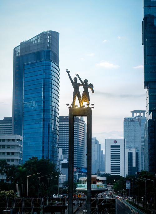 Free Stunning view of Jakarta's skyline featuring the iconic Selamat Datang Monument during blue hour. Stock Photo