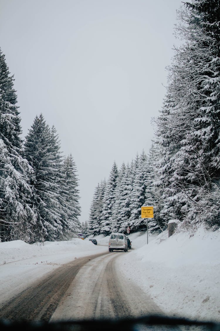 Car Driving On Snowy Road In Winter Day