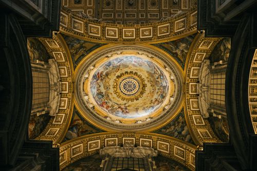 Free A stunning view of the ornate dome interior in St. Peter's Basilica, showcasing intricate frescoes and architectural details. Stock Photo