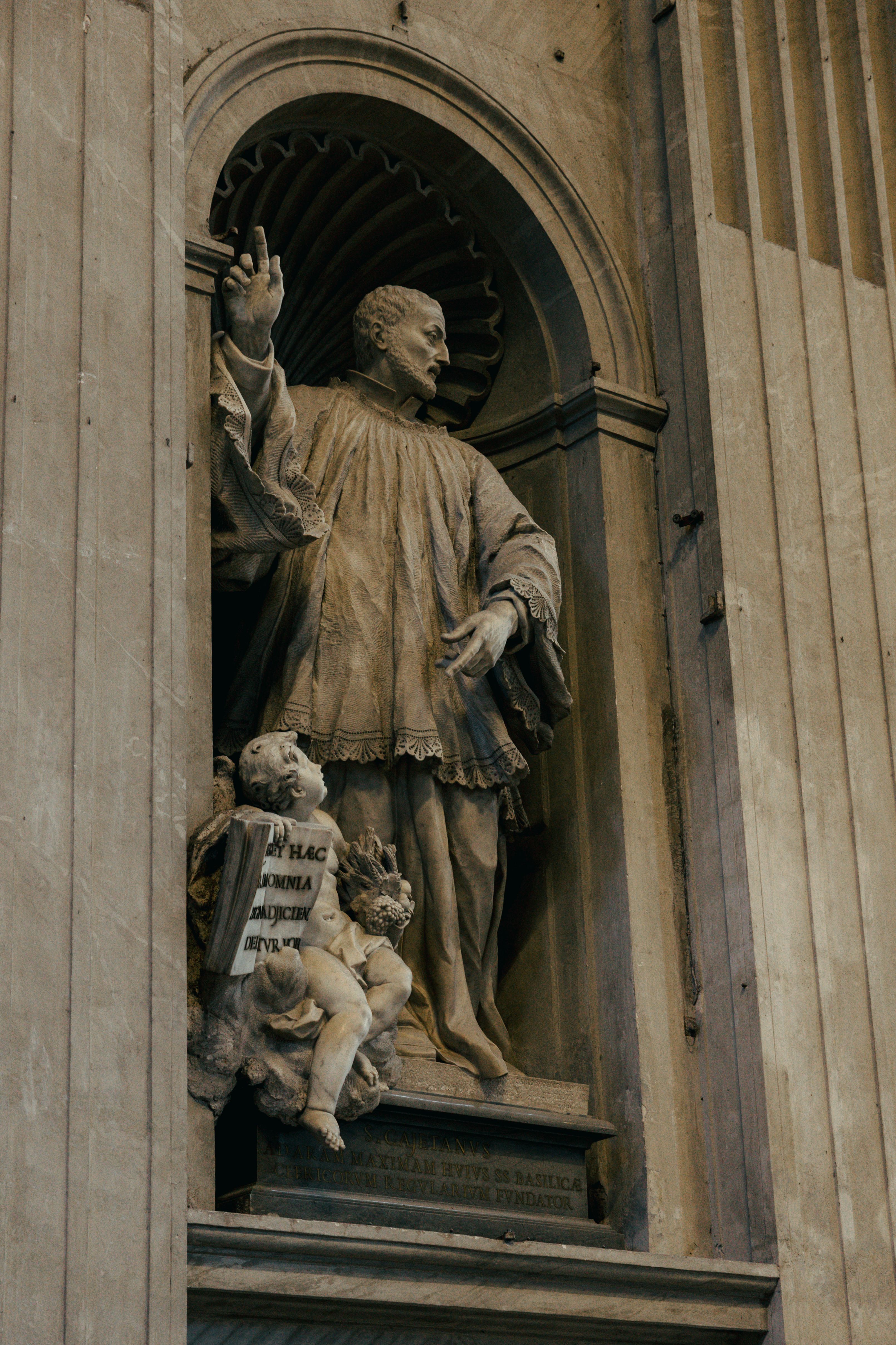 Elegant marble statue in a Roman church showcasing Renaissance artistry.