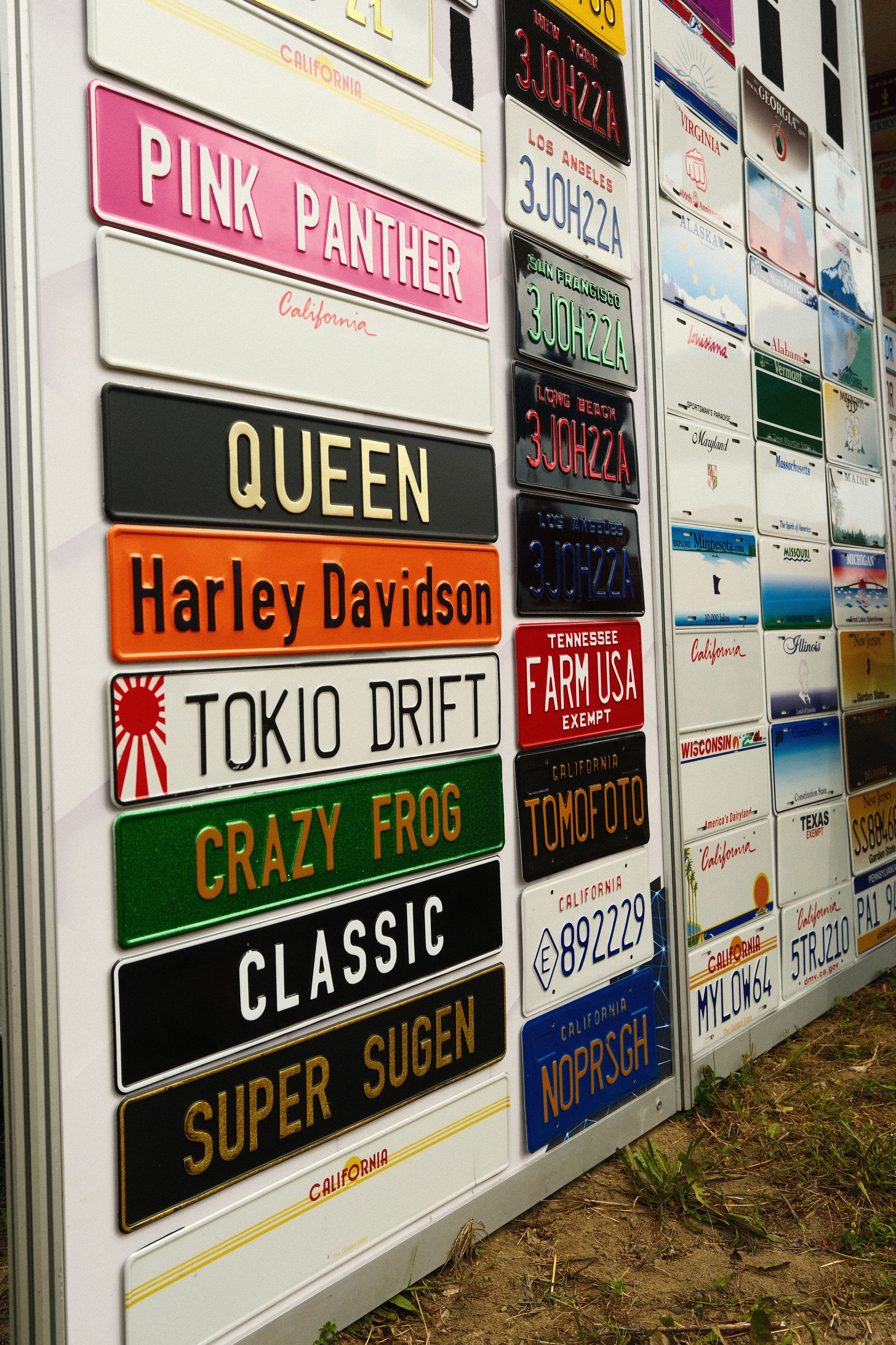A vibrant display of various novelty license plates in Katowice, Poland.