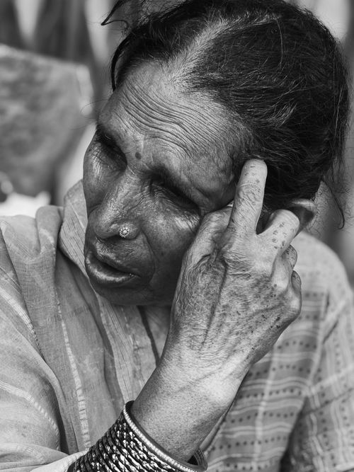 Free Close-up black and white portrait of an elderly woman deep in thought. Stock Photo