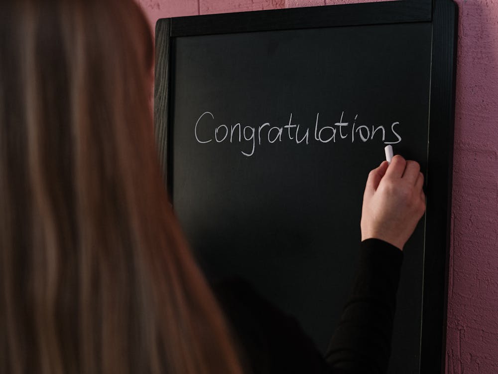 Free Woman in Black Long Sleeve Shirt Writing on the Chalkboard Stock Photo