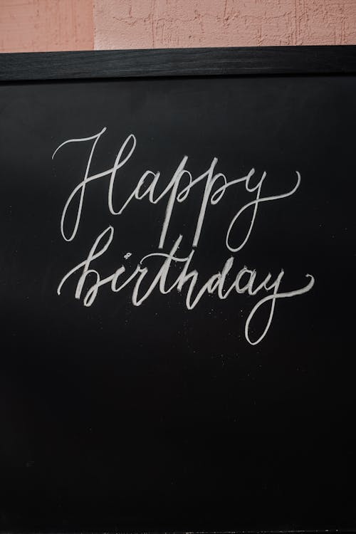 Free Happy Birthday Text on a Black Board Stock Photo