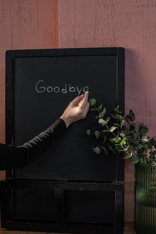 Free Person Writing on Black Board with Chalk Stock Photo