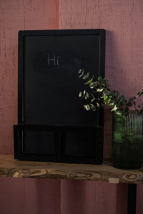 Free A vertical shot of a small chalkboard with 'Hi' written, adorned with a decorative plant. Stock Photo