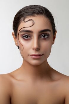 Portrait of a woman with elegant hairstyle and makeup, showcasing natural beauty and fashion.