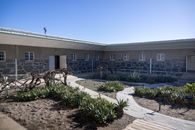 Outdoor courtyard of a prison cell block at Robben Island on a sunny day.