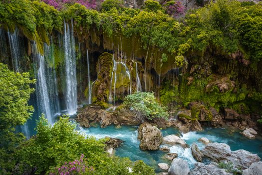 Stunning waterfall amidst lush greenery and turquoise waters in Mersin, Türkiye.