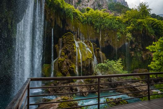 Majestic waterfall cascading over vibrant green moss in Mersin, Türkiye.