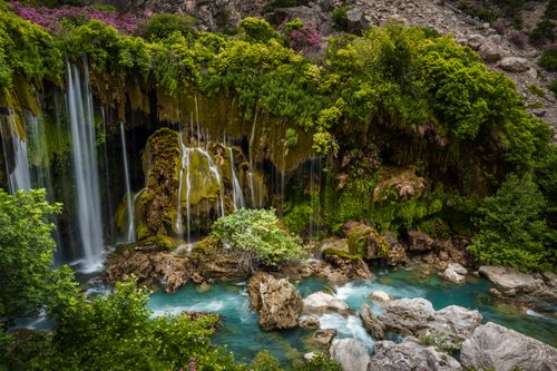 Free Vibrant waterfall surrounded by lush greenery in Mersin, Türkiye. Stock Photo