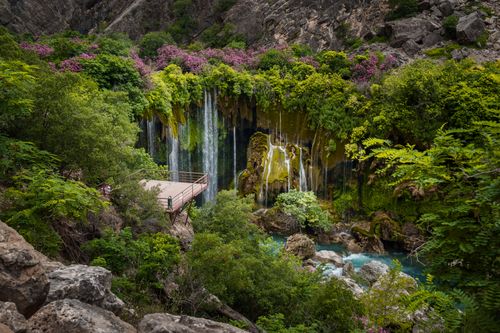 Free Lush greenery surrounds a stunning waterfall in Mersin, Türkiye, showcasing nature's beauty. Stock Photo