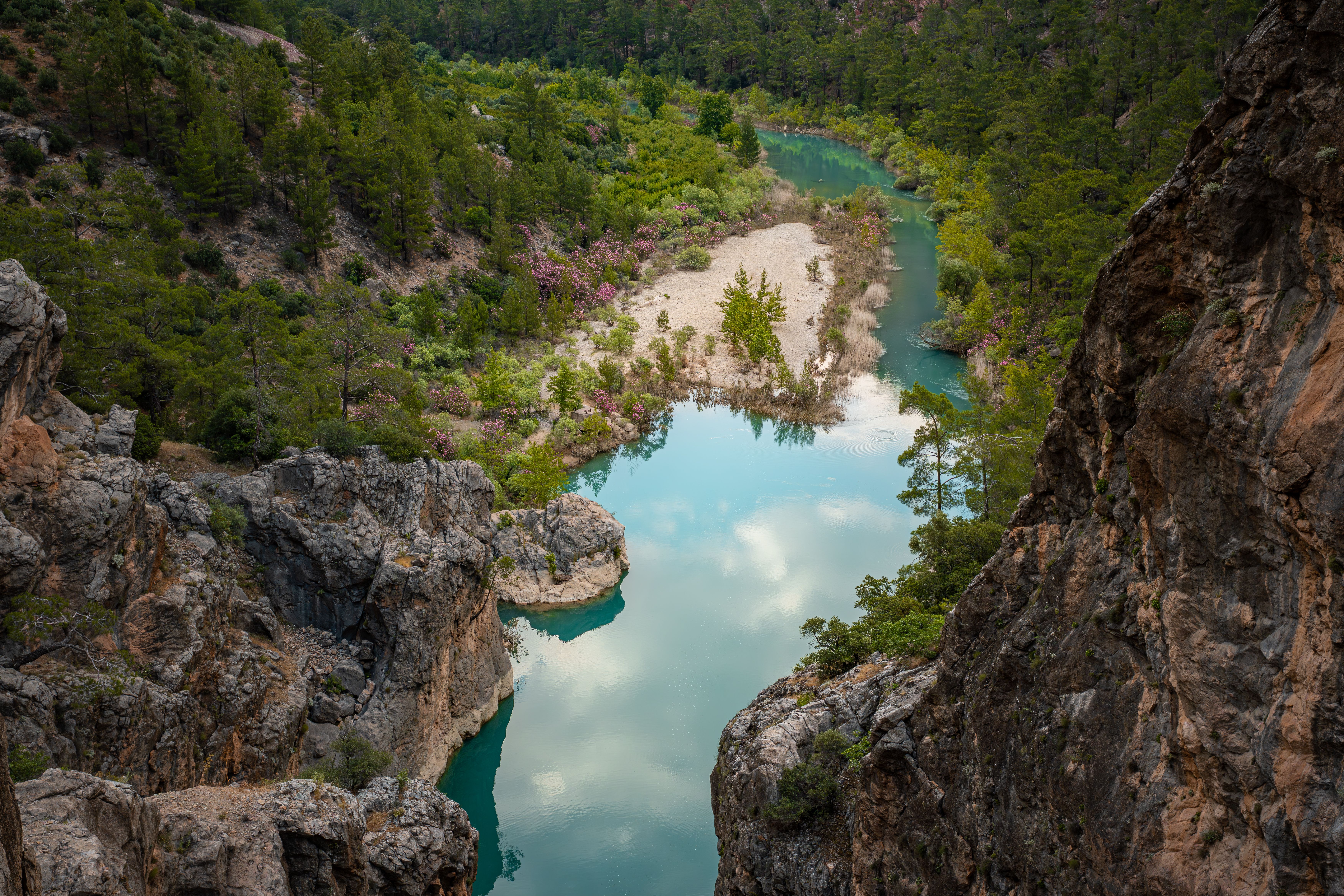 A stunning view of a turquoise river flowing through lush greenery in Mersin, Türkiye.