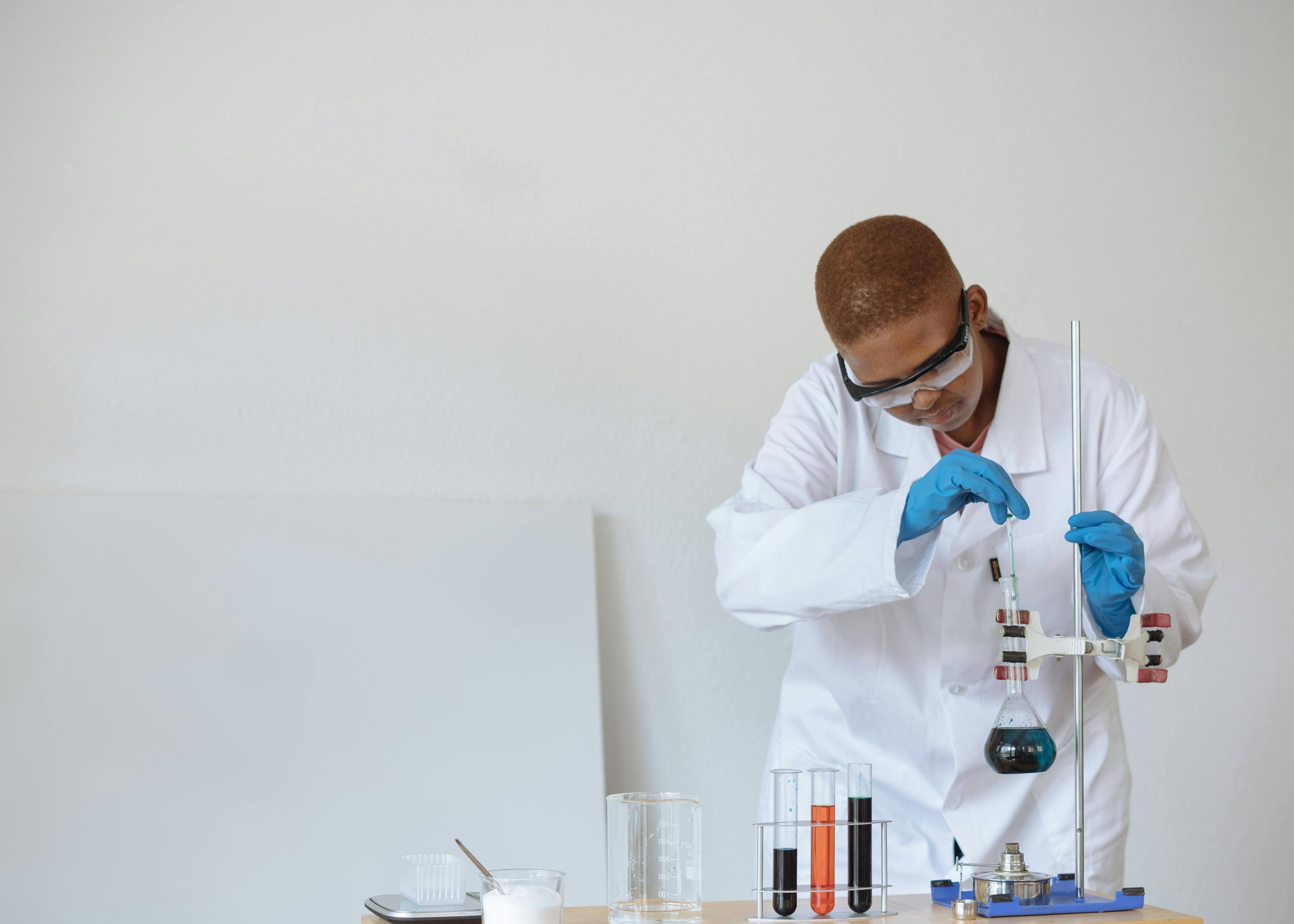 teenage student conducting research in chemical laboratory