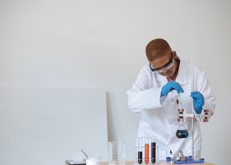 Teenage Student Conducting Research In Chemical Laboratory