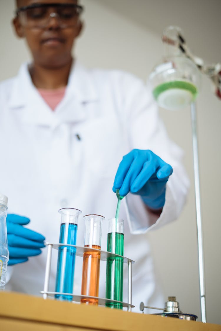 Crop Laboratory Technician Working With Colorful Reagents In Test Tubes In Lab