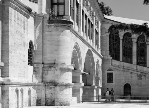 Free Black and white image of historic stone architecture with arches and windows. Stock Photo