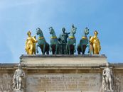 Detailed view of statues atop Arc de Triomphe du Carrousel in Paris, France.