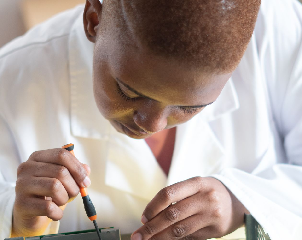 Technology specialist carefully inspecting computer hardware in a workshop