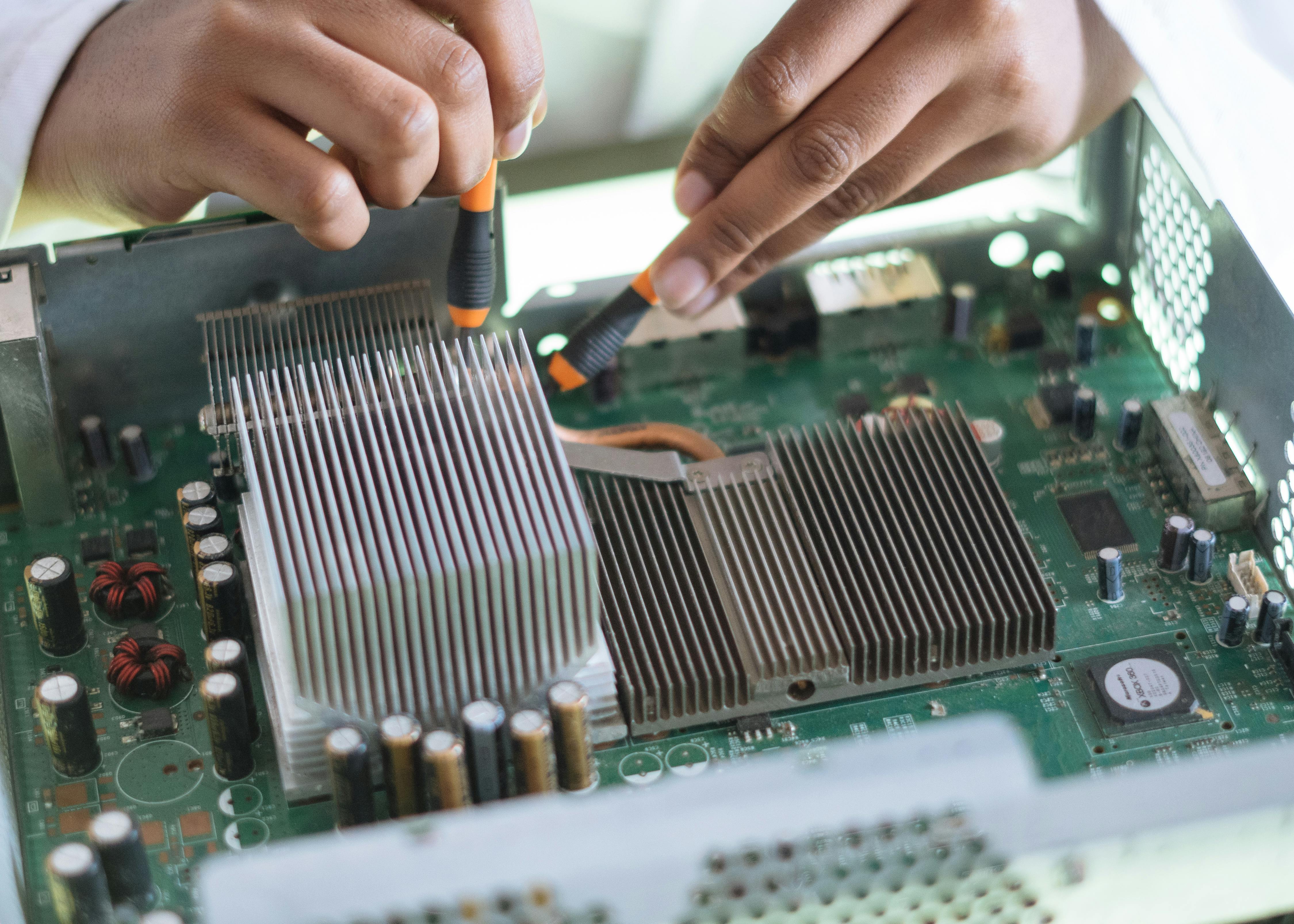 crop technician checking contacts on motherboard in workshop