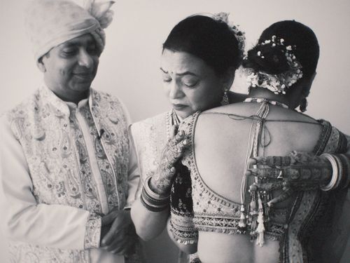 Free Touching moment as family embraces at traditional Indian wedding, highlighting cultural attire and emotion. Stock Photo