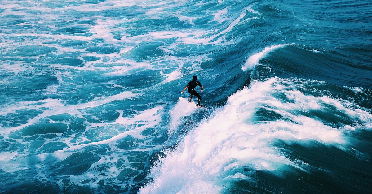 Dynamic shot of a surfer catching waves in ocean waters of San Clemente, CA.